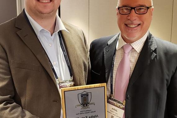 John Perlich with student holding award in 2022